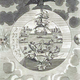 Mutus Liber. An enthroned king holding a sceptre while seated atop a large black bird in the clouds, positioned above a large spherical diagram of concentric rings containing animals, fish, and birds, flanked by a stylised Sun and Moon.